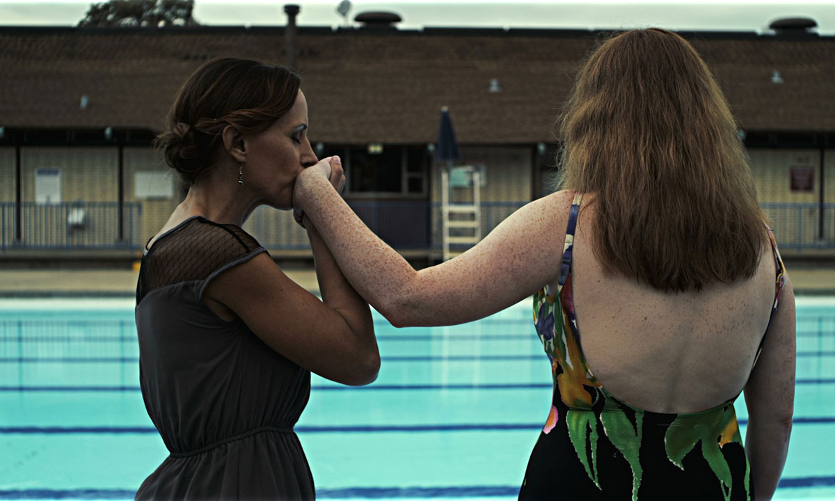two women near a swimming pool
