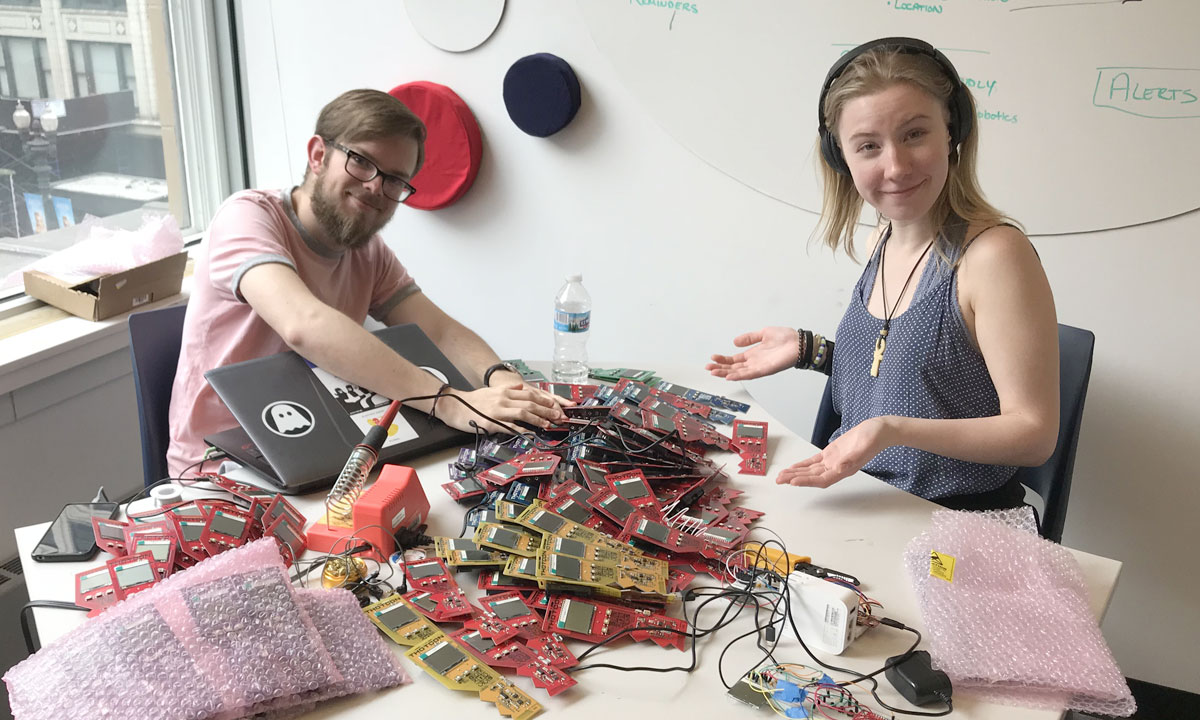 two students with a lot of parts on table